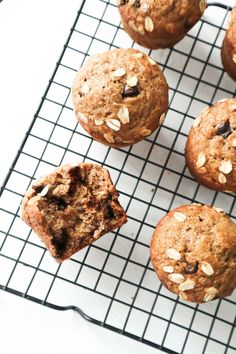 muffins cooling on a wire rack with oats and raisins in them