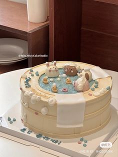 there is a cake decorated with animals in the bathtub on top of a table