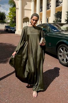 Elevate your elegance with the Olive Drape Kaftan, a harmonious blend of sophistication and versatility. Crafted in a deep olive hue, this kaftan features a discreet string inside that allows you to tie and shape it around your waist, making it fit all body types. The flowing fabric and relaxed fit ensure effortless movement, offering a look that radiates serene beauty and timeless charm. Size details This versatile free-size kaftan is available in two lengths to suit your preference. Size 55 me Abayas Collection, Abaya Dresses, Eid Outfits, Flowing Fabric, Abaya Dress, City Chic, Casablanca, Hijab Fashion