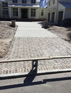 a brick walkway in front of a house