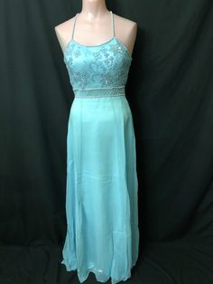 "This beautiful long powder blue gown has beaded spaghetti straps and a decorated bust.  It is fitted through the chest and waist and flares out from the hips.  This gown is in excellent condition and available in different sizes.  Measurements for this gown are in a Size : Size-4                                       Size-8                                Size-10                                 Size-12                        Size-14                                       Chest - 31\" Light Blue Embellished Gown For Prom, Light Blue Embellished Gown For Prom Season, Light Blue Evening Dress With Fitted Bodice For Prom, Light Blue Fitted Bodice Evening Dress For Prom, Light Blue Fitted Evening Dress For Prom, Light Blue Fitted Bodice Floor-length Evening Dress, Light Blue Floor-length Evening Dress With Fitted Bodice, Light Blue Fitted Floor-length Evening Dress, Light Blue Floor-length Evening Dress For Debutante Ball