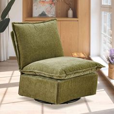 a green chair sitting on top of a hard wood floor