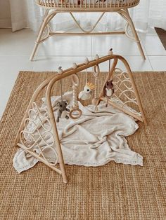 a baby crib with stuffed animals in it on a rug next to a window