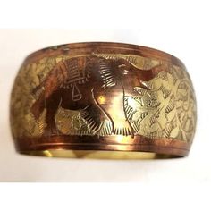 Elevate your style with this bangle that screams, "I have great taste and I know it!" Perfect for adding a touch of vintage charm to any outfit.  With Intricate Elephant & Floral Animal Engravings Made in India. * Handcrafted vintage bangle * Brass and copper materials * Intricate animal engravings * Inner diameter: 2.7 inches * Outer diameter: 3.07 inches * Width: 1.47 inches Item will be well packed to prevent shipping damage. Luxury Traditional Carved Cuff Bracelet, Brass And Copper, Vintage Bangles, Copper Material, I Know It, Vintage Charms, Bangle Bracelet, Vintage Brass, Bangle Bracelets