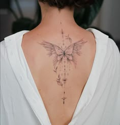 a woman with a butterfly tattoo on her back