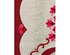 a red and white wall hanging with flowers on it