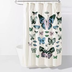 a shower curtain with butterflies printed on it