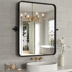 a bathroom sink sitting under a large mirror