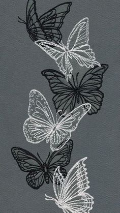 three black and white butterflies on a gray background