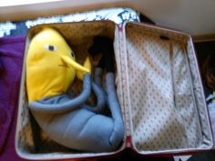 an open suitcase with stuffed animals in it