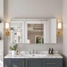 a bathroom vanity with two mirrors and lights on the wall next to it is shown