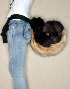 a woman is standing on the floor with her back turned to the camera and she's wearing blue jeans