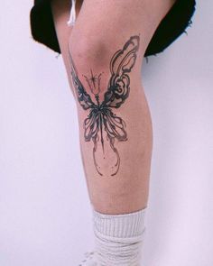 a woman's leg with a butterfly tattoo on her left calf and the bottom part of her leg