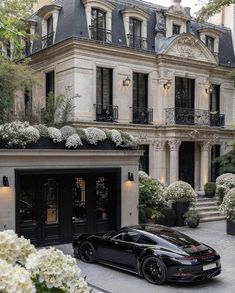 a black sports car parked in front of a building