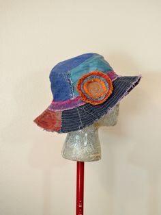 "Hat #230 In my collections of dyed denim. I have taken my scrap pieces and cut them into circles and bands - dyed and fringed and sewn together. A free-motion stitching in thread is used in the center of these circles and on the hat. The Hat is an hand made bucket/beach Hat made from dyed denim pieces. It has a pocket on the inside of the hat. The hat is measures at 24\" (61 cm) in diameter at the band with a 2.5\" (6 cm) bill and 3\" (8 cm) hat depth. It has an interior pocket in the roof of t Upcycled Hats, Bucket Hat Ideas, Handmade Fabric Purses, Bucket Hat Pattern, Sewing Hats, Funky Hats, Bucket Hat Design, Denim Hat, Hat Patterns To Sew