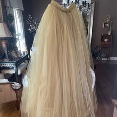 This Is A Custom Made Tulle Skirt In A Champagne Color By Sweet Caroline Styles. The Top Is An Ivory Lace With Gold Accents. It Is A Women’s Size 6 And Is Brand New And Comes With The Original Dress Bag. The Top And Skirt Were Originally Sold Separately. The Savannah Top Was $350.00 And The Norma J Skirt Was $1,350.00 Elegant Full Skirt Tulle Bottoms, Formal Tulle Skirt With Voluminous Fit, Formal Voluminous Tulle Skirt, Formal Tiered Tulle Skirt, Formal Long Tulle Skirt, Beige Flared Skirt For Wedding, Tulle Flared Skirts For Wedding, Spring Formal Tulle Skirt, Tulle Flared Wedding Skirt