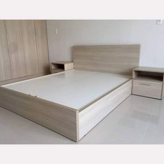 a bedroom with a bed, nightstands and cabinets