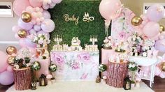 a baby shower party with pink and gold balloons