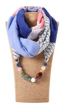 Elevate your style with this bohemian-inspired chiffon necklace pendant scarf. The colorful, multicolored design adds a trendy touch to any outfit. Perfect for those who love unique and stylish accessories, this pendant scarf is a great addition to your fashion jewelry collection. The necklace pendant scarf features a bohemian style that will surely turn heads. Ideal for women who love to accessorize, this pendant scarf is perfect for any occasion. Whether you're dressing up for a formal event or simply adding some flair to your everyday outfit, this boho necklace pendant scarf is the perfect choice. Bohemian Blue Necklaces For Spring, Bohemian Scarves For Spring Gift, Elegant Multicolor Beach Scarves, Elegant Multicolor Beach Scarf, Bohemian Multicolor Scarves, Everyday Outfit, Boho Necklace, Stylish Accessories, Necklace Pendant