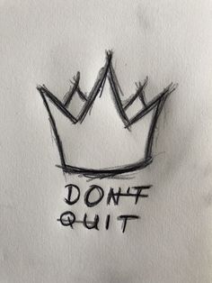 a drawing of a crown with the words don't quit written on it in black ink