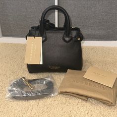 Burberry Baby Banner Black Leather Handbag Brand New, Tags Attached, Dust Bag Included, Care Cards Included, Shoulder Strap Included Designer: Burberry Article Number: 8036492 Style: Tote/Shoulder Bag Condition: New With Tags And Dust Bag Measurements: 10.5” Long, 8” High, 4.5” Deep Size: Small/ “Baby Banner” Material: Leather Color: Black Hardware Color: Polished Gold-Tone Msrp Us $1150 Burberry Baby, Banner Material, Banner Black, Burberry Tote, Black Leather Handbag, Baby Banners, Black Handbag, Bag Measurements, Small Baby