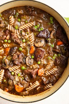 a pot filled with pasta and meat soup