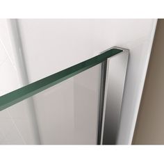 an open glass door on the side of a white wall with green trim around it