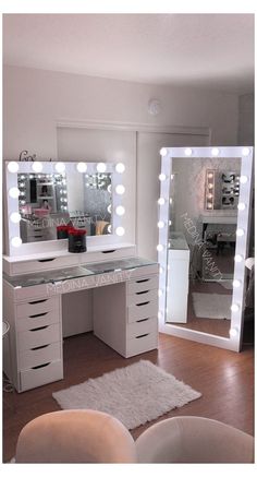 a white vanity with lighted mirrors and stool