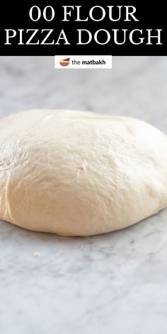 a close up of a pizza dough on a table with the words, how to make 50 flour pizza dough