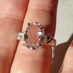 This Gorgeous, Morganite ring has a 10mm x 14mm faceted, lavender, sparkling gemstone, set in a Sterling Silver ring Setting, (hallmarked 925,) with six small sparkling White Sapphires, (3 tiny accent stones on each side.) This is a new casting, with a size 7 ring, and a flawlessly Beautiful large Gemstone. It would make a treasured gift for that special lady, (even if that be yourself.) Oval Faceted Rings In Fine Jewelry Style, Oval Faceted Topaz Ring In Sterling Silver, Faceted Oval Topaz Ring In Sterling Silver, Oval Amethyst Ring With Diamond Cut, Oval Diamond Cut Amethyst Ring, Oval Faceted Gemstones For Fine Jewelry, Oval Faceted Rings For Anniversary, Fine Jewelry Oval Amethyst Ring With Diamond Cut, Fine Jewelry Diamond Cut Oval Amethyst Ring