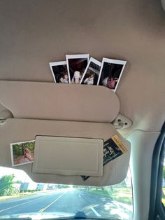 the back seat of a car with pictures hanging on it