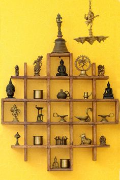 a wooden shelf filled with lots of different types of figurines on top of it