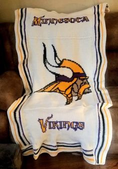 the minnesota viking blanket is sitting on top of a chair in front of a couch