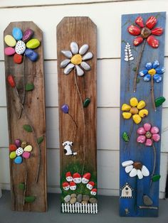 three wooden boards with flowers painted on them