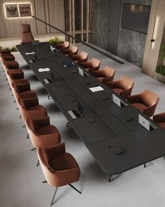 an empty conference table with chairs around it