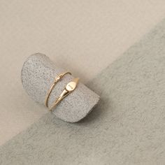 Our modern, minimalist take on the classic signet ring. A little bold and a little dainty, this everyday 14k solid gold ring is a jewellery essential. 14k recycled solid gold Tapered metal ring band width from 5mm at the front to 1mm at the back of ring band Pinky Signet Ring, Gold Bar Bracelet, Signet Rings Women, Silver Coin Necklace, Gold Coin Necklace, White Sapphire Ring, Signet Rings, Jewellery Inspiration, Solid Gold Ring