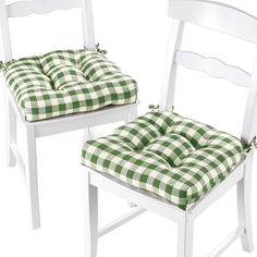 two white chairs with green and white checkerboard cushions, one has a seat pad on the back