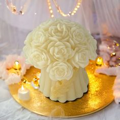 there is a cake with flowers on it and candles around the cake, along with other decorations