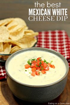 a bowl of dip with tomatoes and tortilla chips