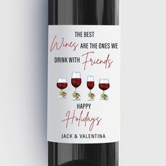 a bottle of wine with three glasses of red wine on the front and one is labeled happy holidays