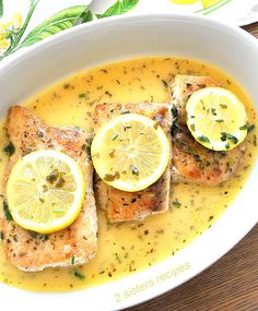 fish with lemon sauce in a white bowl