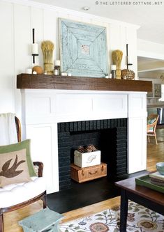 a living room filled with furniture and a fire place under a painting on the wall