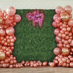 a backdrop made out of balloons and grass