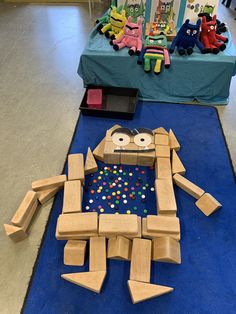 a cardboard robot made to look like it is playing with toys