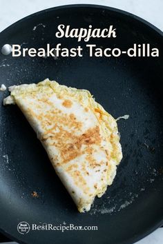 a skillet with some food in it on top of a table and the words slapjack breakfast taco - dila