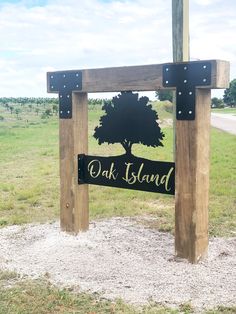 a wooden sign that says oak island with a tree in the center and words on it