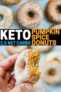 a person holding up a donut in front of other doughnuts with the words keto pumpkin spice donuts