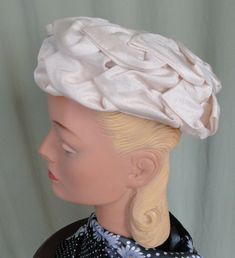 "This is a chic, vintage, beige hat, that dates from the 1950s or 60s. No labels or tags. It is a pillbox style. It features a double layer of fabric, overlapping leaves. The inside is a formed mesh. It measures 21\" around the inside. It is in very good, vintage condition. No soil or stains, there is gently wear around the inside edge. Nice & clean. Lovely!" Retro Cream Hat With Curved Brim, Beige Cloche Hat For Church, Vintage Cream Fascinator For Spring, Vintage Cream Fascinator For Evening, Fitted Retro Cream Hat, Retro Fitted Cream Hat, Retro Cream Hat, Vintage Beige Fascinator For Evening, Vintage Cream Fascinator For Church