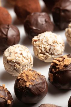 there are many different types of chocolates on the table, including one with nuts