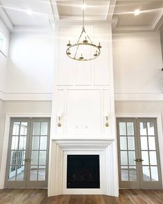 an empty living room with white walls and wood floors